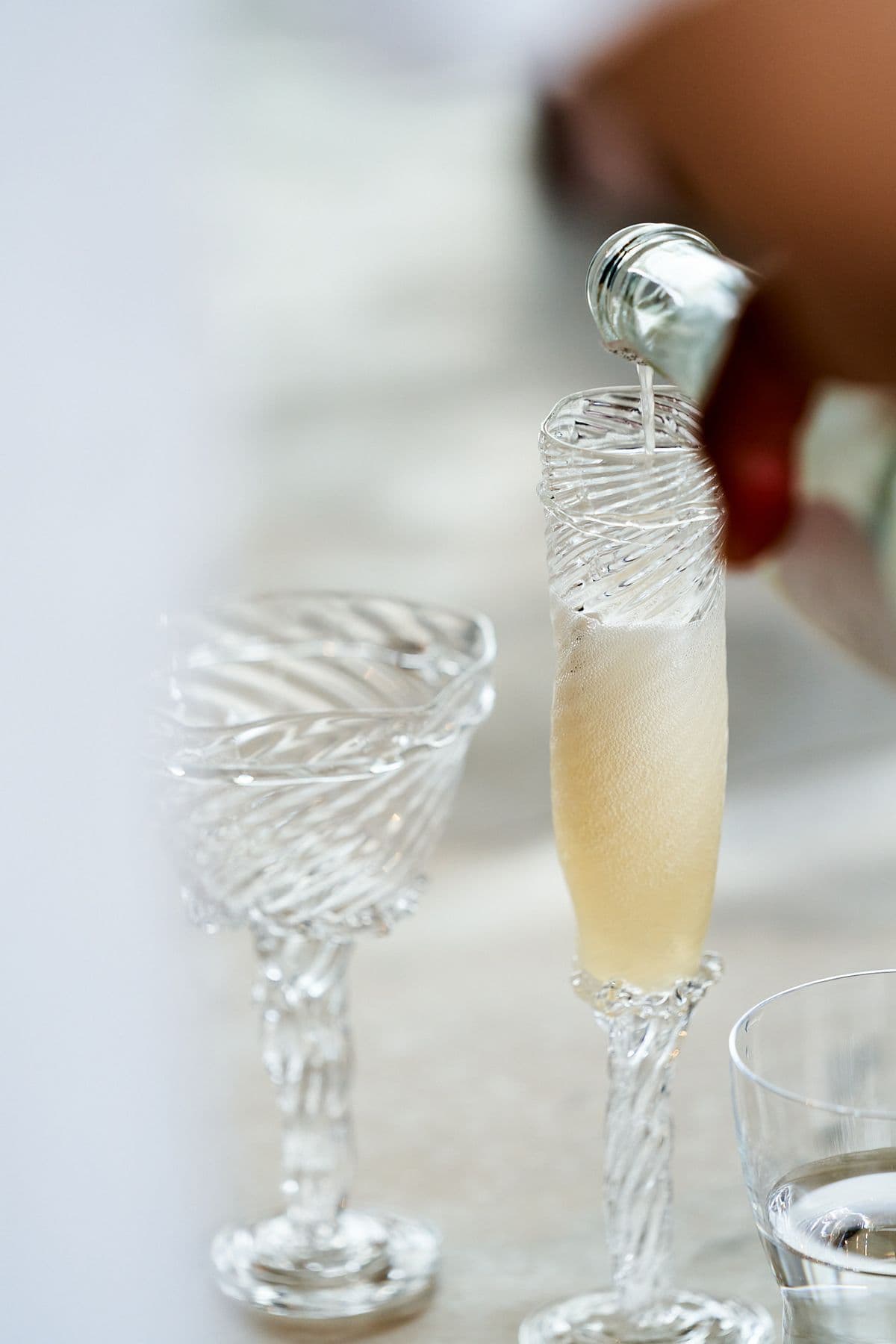 Close-up of bubbles being poured into glasses, perfect for festive occasions like corporate parties at Mogens Dahl Concert Hall – highlighting elegance and celebration.